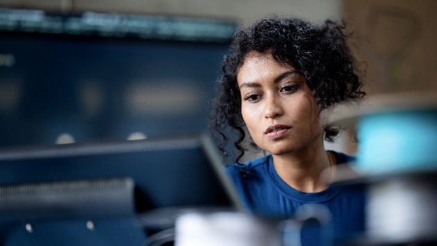Woman At Desk Viewing Computer Screen 