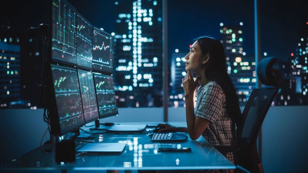 Office Worker Looking At Data In The Evening 