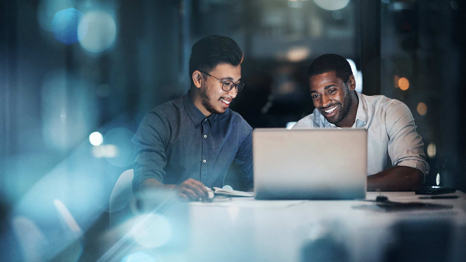 Two Male Coworkers Smiling At Laptop 