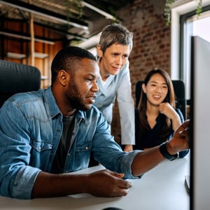 Colleagues Working At Desktop Computer 
