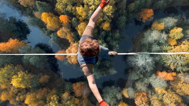 Tightrope Walker Balancing Above Treeline 1 