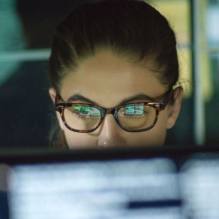 Woman Working With Screen Reflecting On Glasses