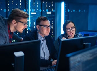 Coworkers Reviewing Data On Screen 