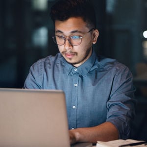 Adjuster Reviewing Claims Package On Computer 