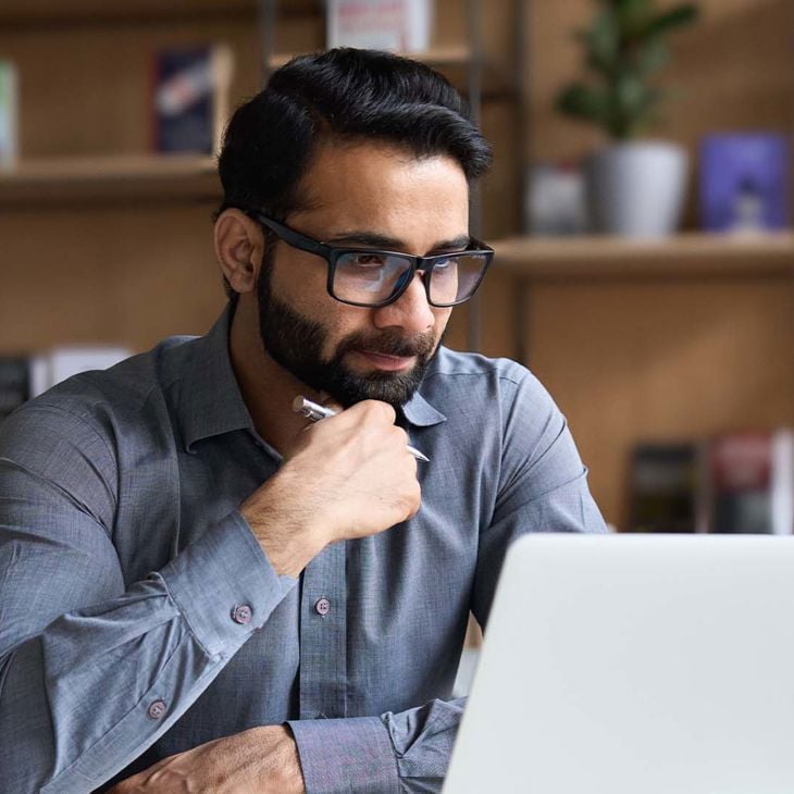 Man Reading Newsletter On Computer 