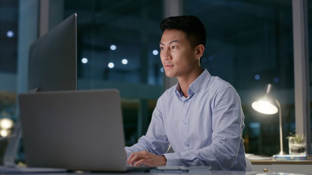 Person Looking At Computer Screens In An Office 