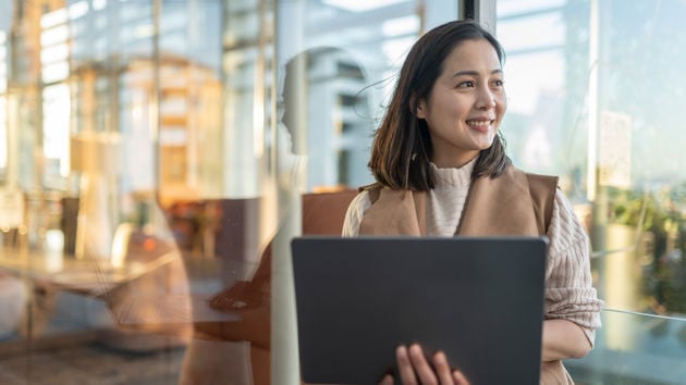 Woman Smiling Holding Laptop 