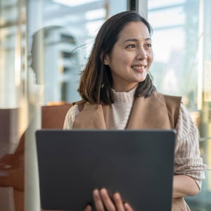 Woman Smiling Holding Laptop 