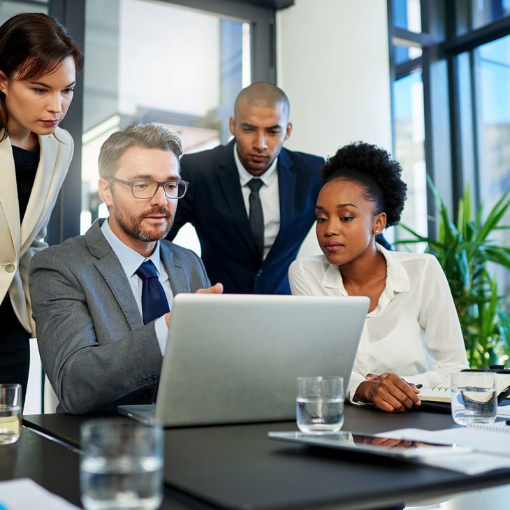 Colleagues Focused On Laptop Screen 
