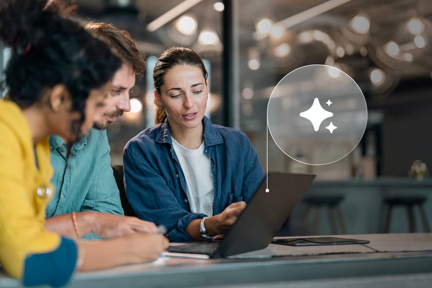 Coworkers Reviewing Ai Data On Laptop Screen 