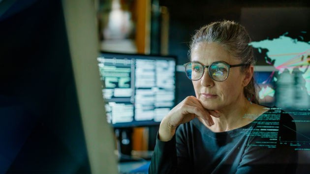 Woman Reviewing Data On Screen Overlay4 