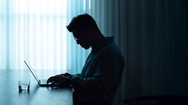 Man Working At Desk Dark 