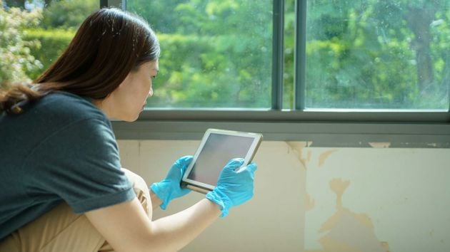 Adjuster Inspecting Damage With Ipad 