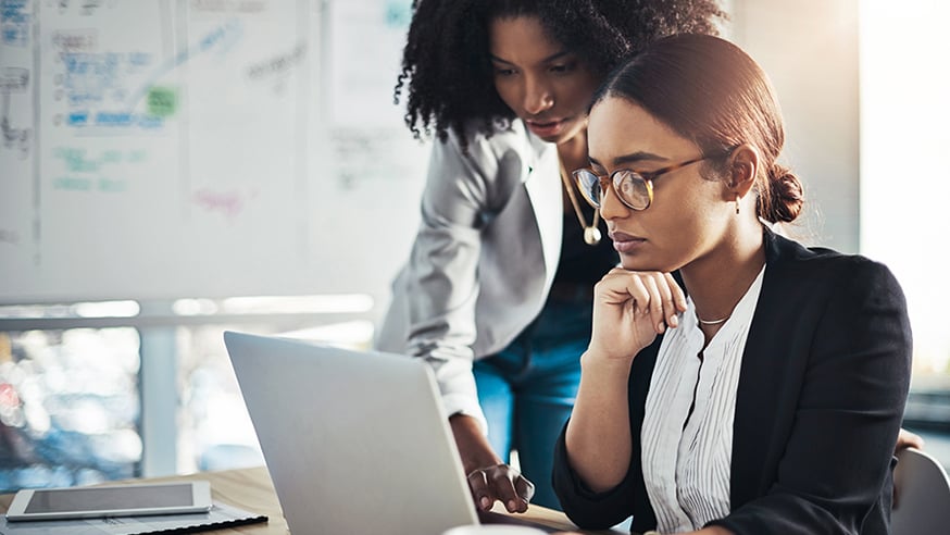 coworkers viewing laptop