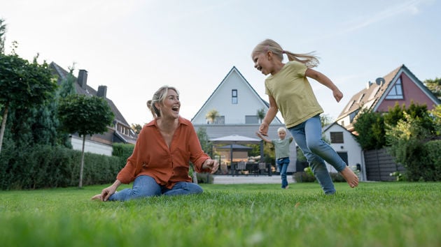 Happy Family Playing In Backyard 