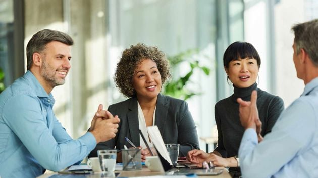 Colleagues Chatting Around Table 