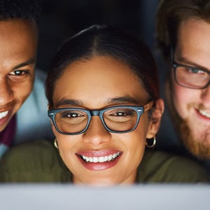 Coworkers Reviewing Data On Computer Monitor 