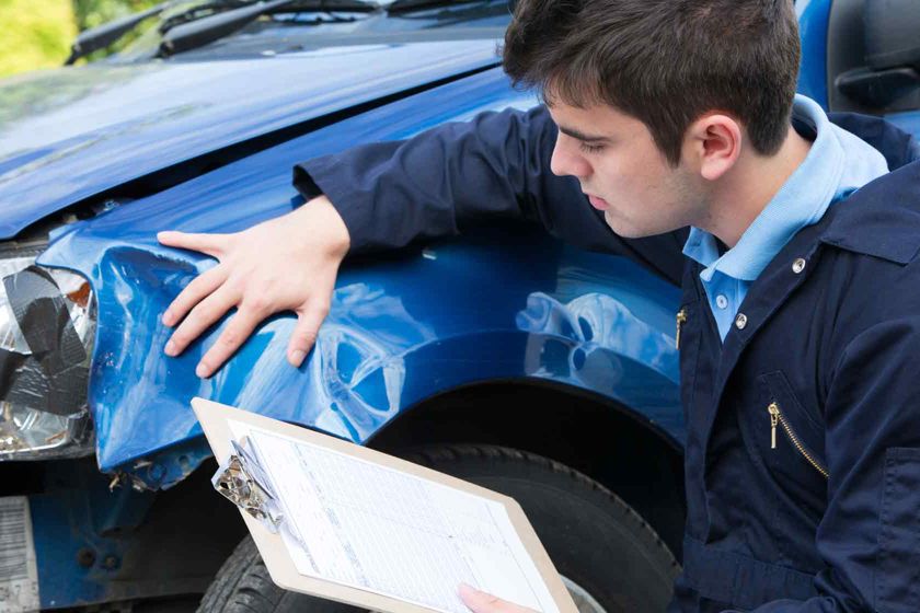 Man With Clipboard Inspecting Broken Fender 