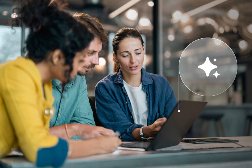 Coworkers Reviewing Ai Data On Laptop Screen 