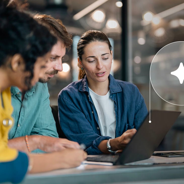 Coworkers Reviewing Ai Data On Laptop Screen 