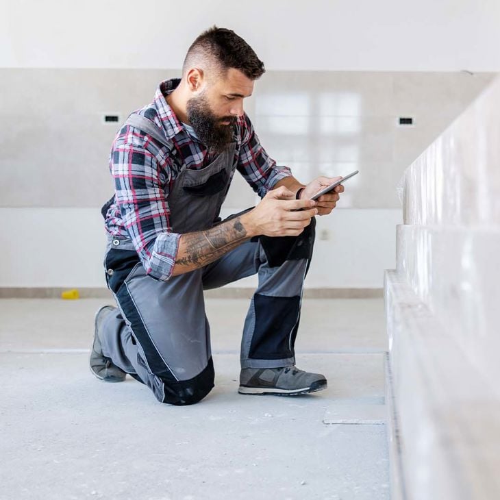 Man Taking Photo Of Building Material 