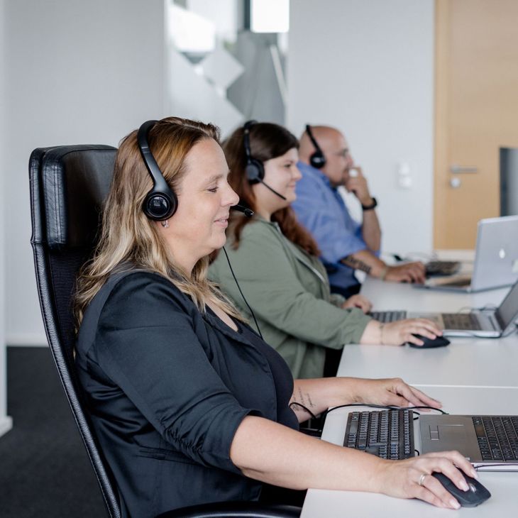 Group Of Customer Service Providers With Headsets 