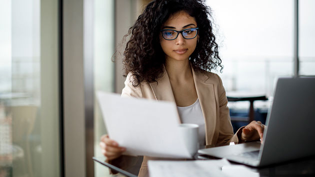 Woman Reviewing Paper 