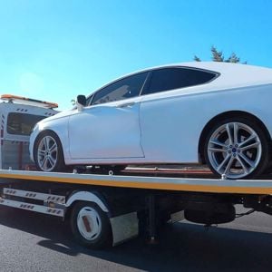 Luxury Car On Back Of Tow Truck 