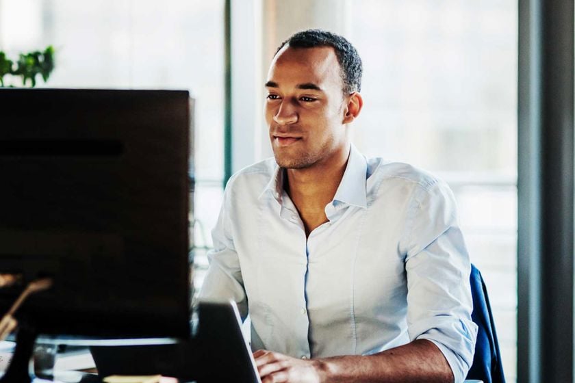 Man Reviewing Data On Screen 