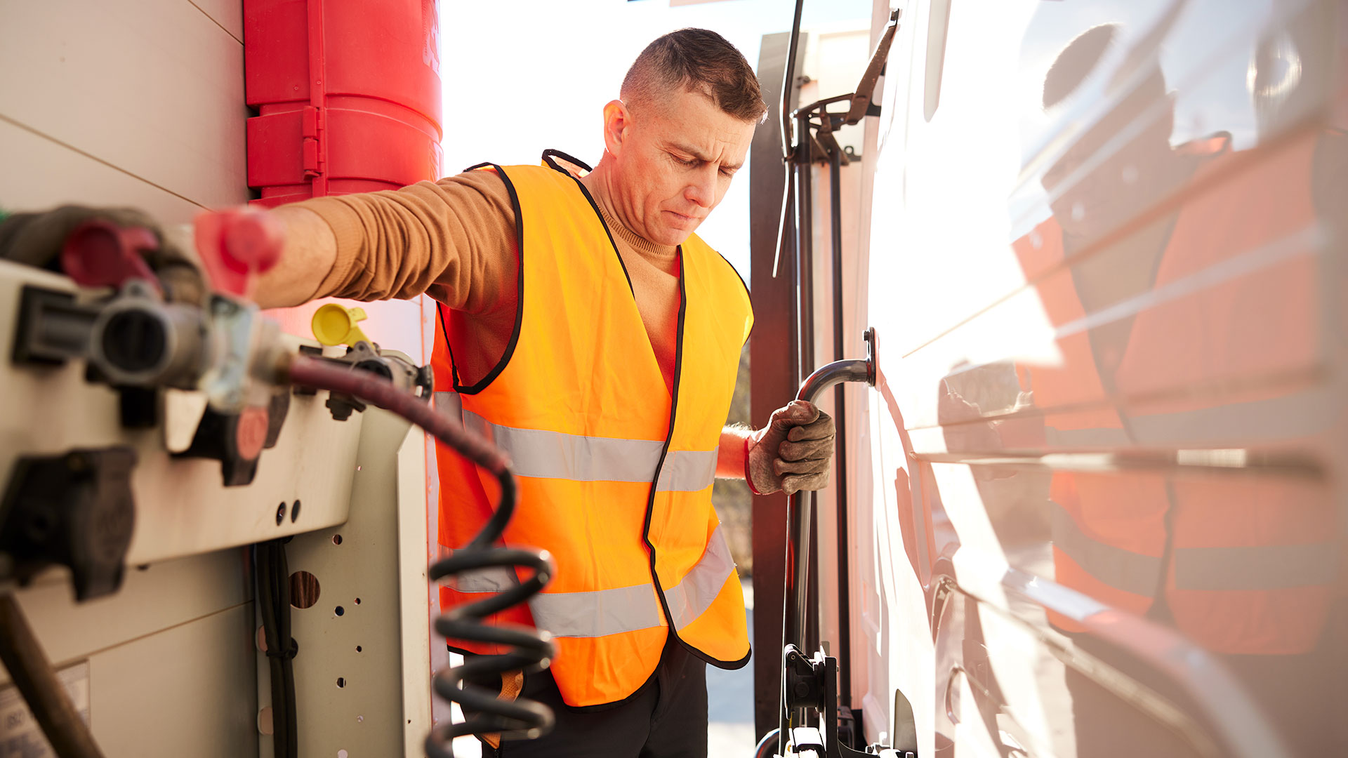 Truck-driver-examining-semi-truck-trailer-brake-coil-for-safety
