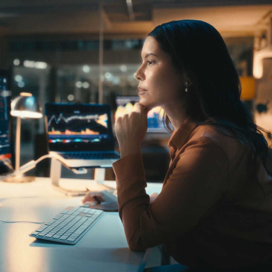 Woman Reviewing Data On Screens 