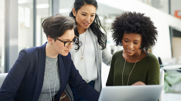 Coworkers Gathered Around Laptop 