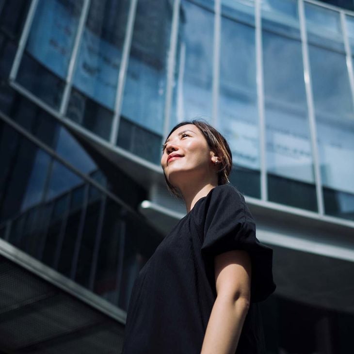 Woman Standing Outside Commercial Building