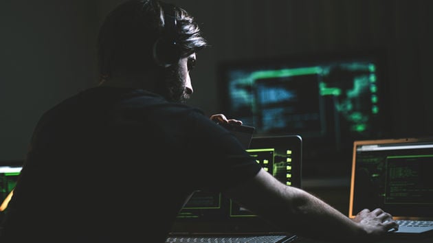 Hacker With Credit Card In Dark Room 