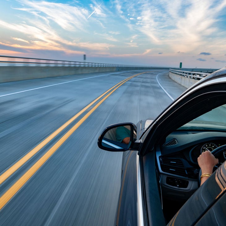 Driving Over Bridge In Sedan 