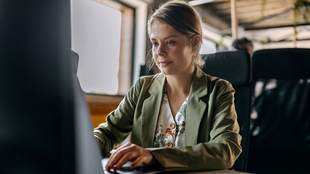 Woman Typing On Desktop 