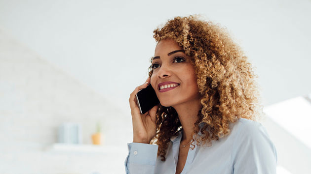 Woman Talking On Phone Holding Paper 