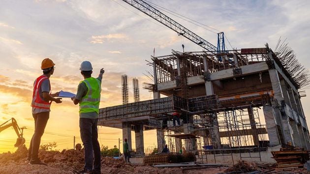 Contractors Reviewing Building Construction 