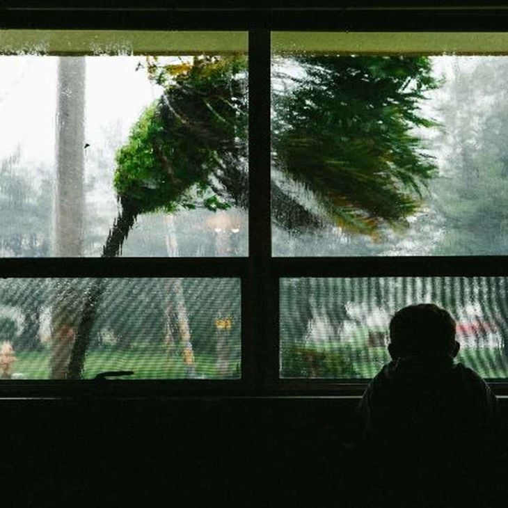 South Korea Typhoon Child Looking Out Window 