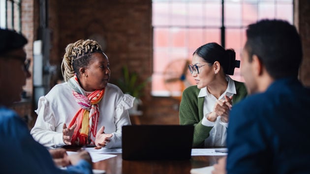Coworkers In Discusssion At Table 