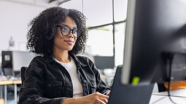 Woman Working At Computer In Office Teaser 