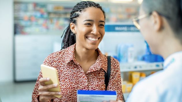 Woman Talking To Pharmacist 