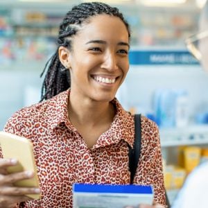 Woman Talking To Pharmacist 