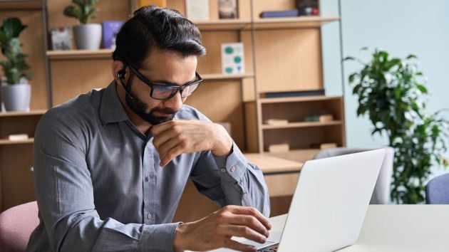 Man Wearing Glasses Working On Laptop 