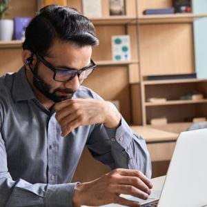 Man Wearing Glasses Working On Laptop 