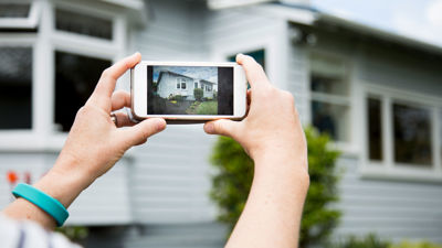 Taking Photo Of Home Exterior On Mobile Phone 